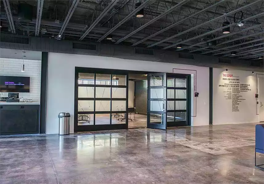 Modern glass garage doors in a office. - henderson garage door services 