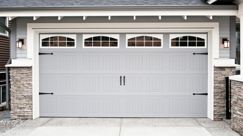Specialty doors - Gray garage door with white windows and black handles and hindles